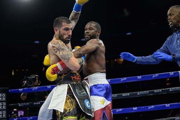 Floyd Mayweather held by John Gotti III during their exhibition boxing match in Sunrise, Florida.